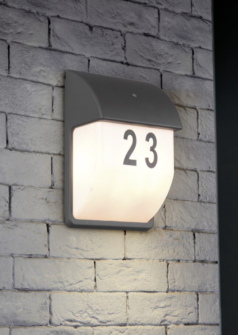 Square steel lamp tungsten/warm light on the white brick wall.