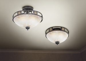 Chandelier on ceiling with classic design decorations and lights on in six lamps.