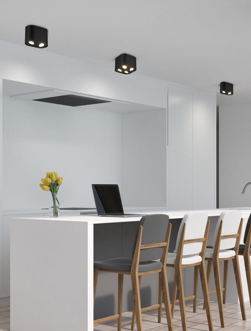 White kitchen with a bar, a gray stools, corner