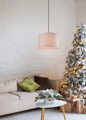 Interior of bright modern living room with comfortable sofa decorated with Christmas tree and gifts