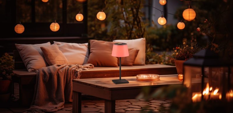 Autumn terrace with couch and candles in the fall garden