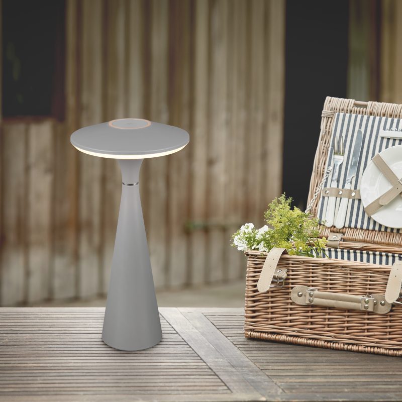 Open fitted wicker picnic hamper on a garden table